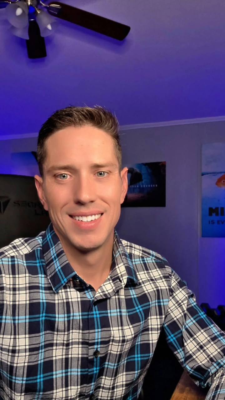 Jonathon Dawley smiling, wearing a blue plaid shirt